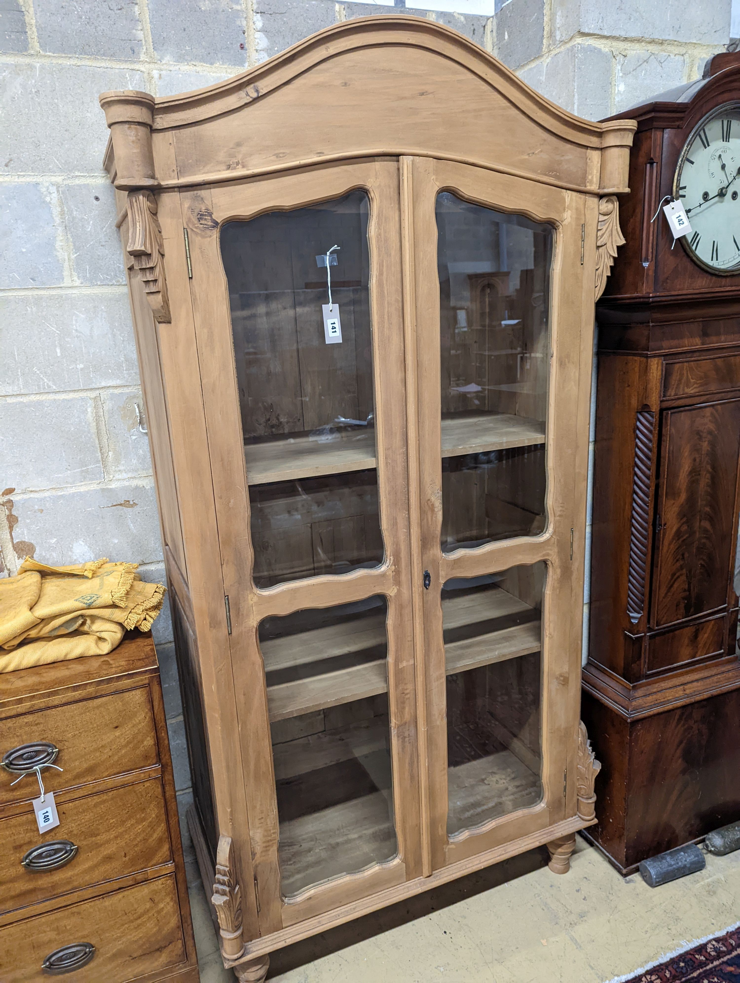 A French glazed pine two door armoire, width 100cm, depth 55cm, height 200cm